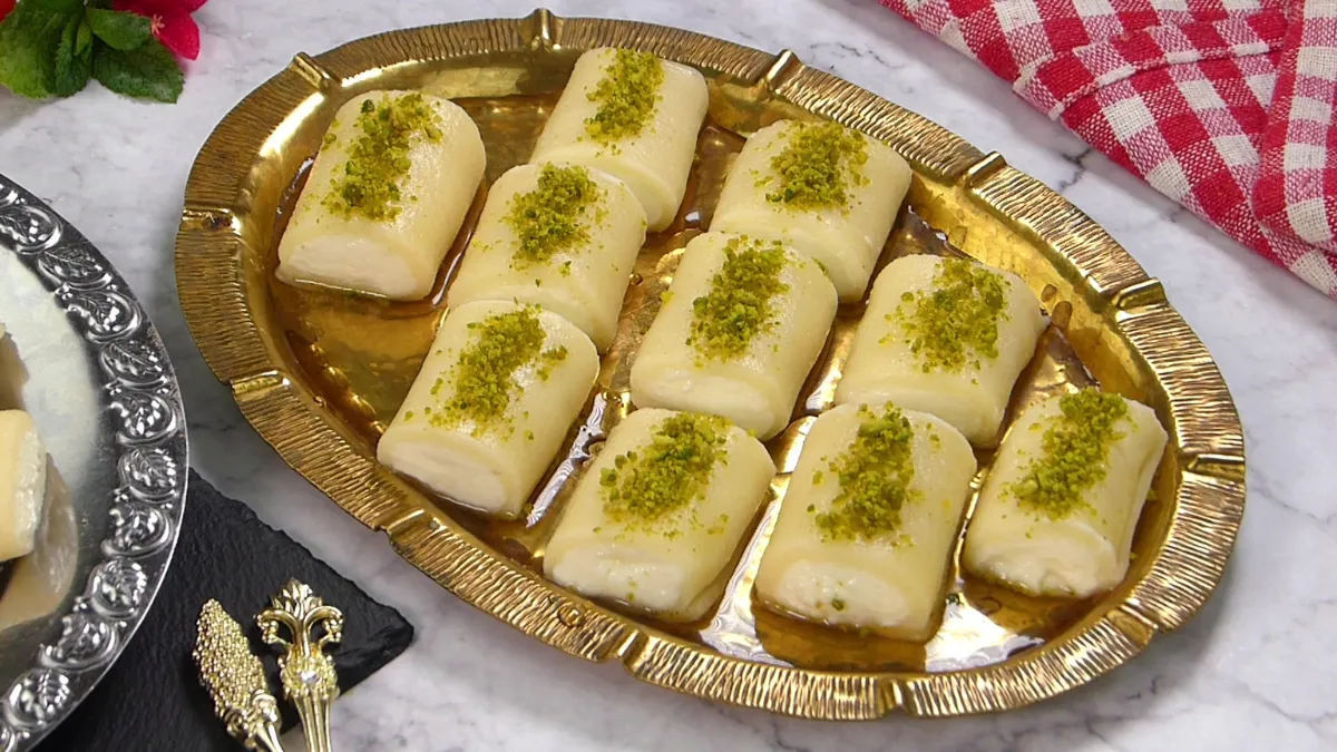 Slices of albat al-jibn topped with crushed pistachios